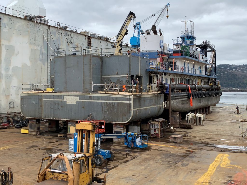 A view of the Dredge Oregon from the back, with one-third of the ship cut off to prepare for maintenance 