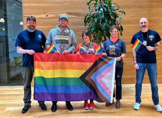 Port employees carry an inclusive Pride flag